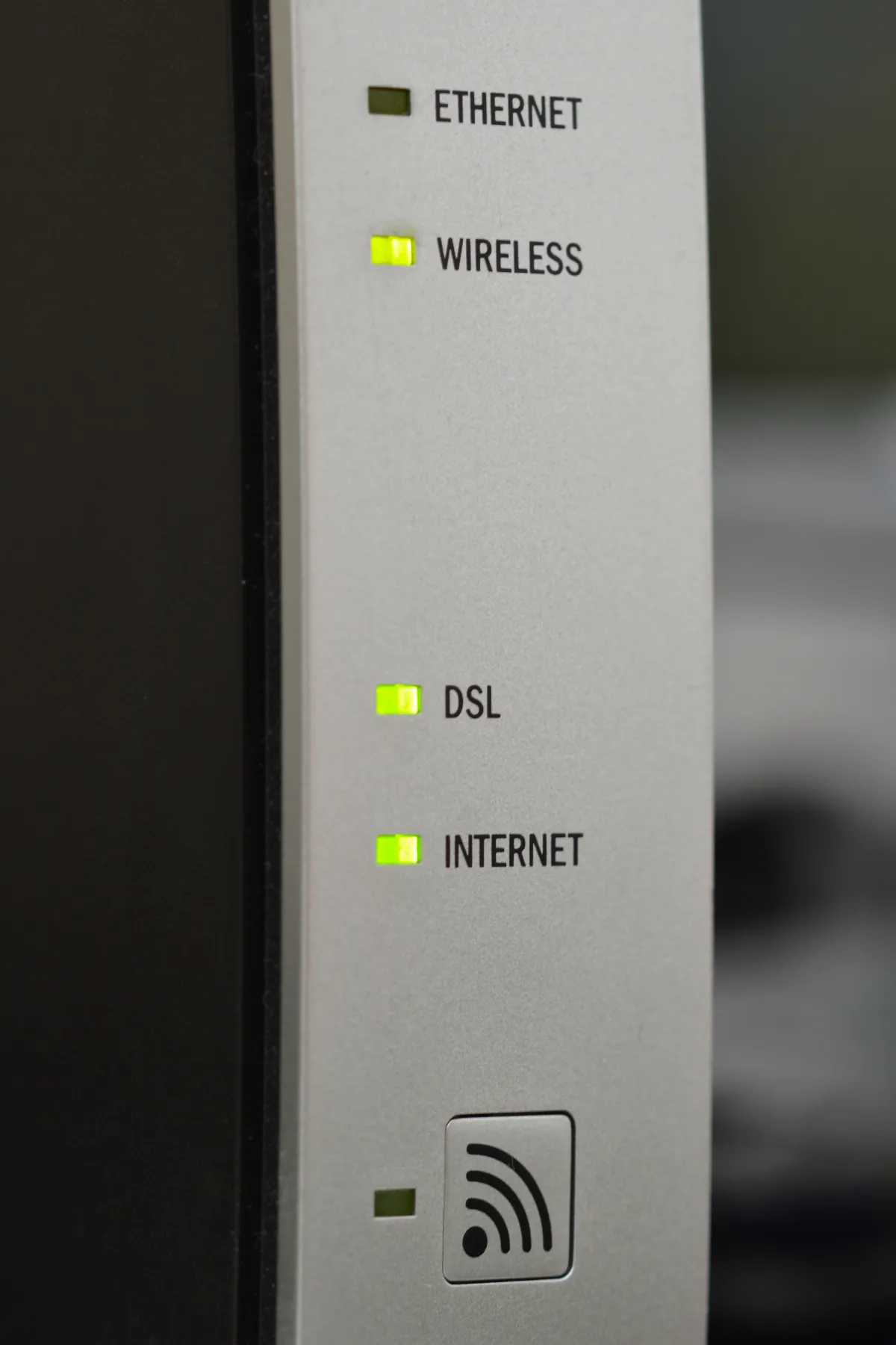Close-up of router indicator lights with labels for Ethernet, Wireless, DSL and Internet.