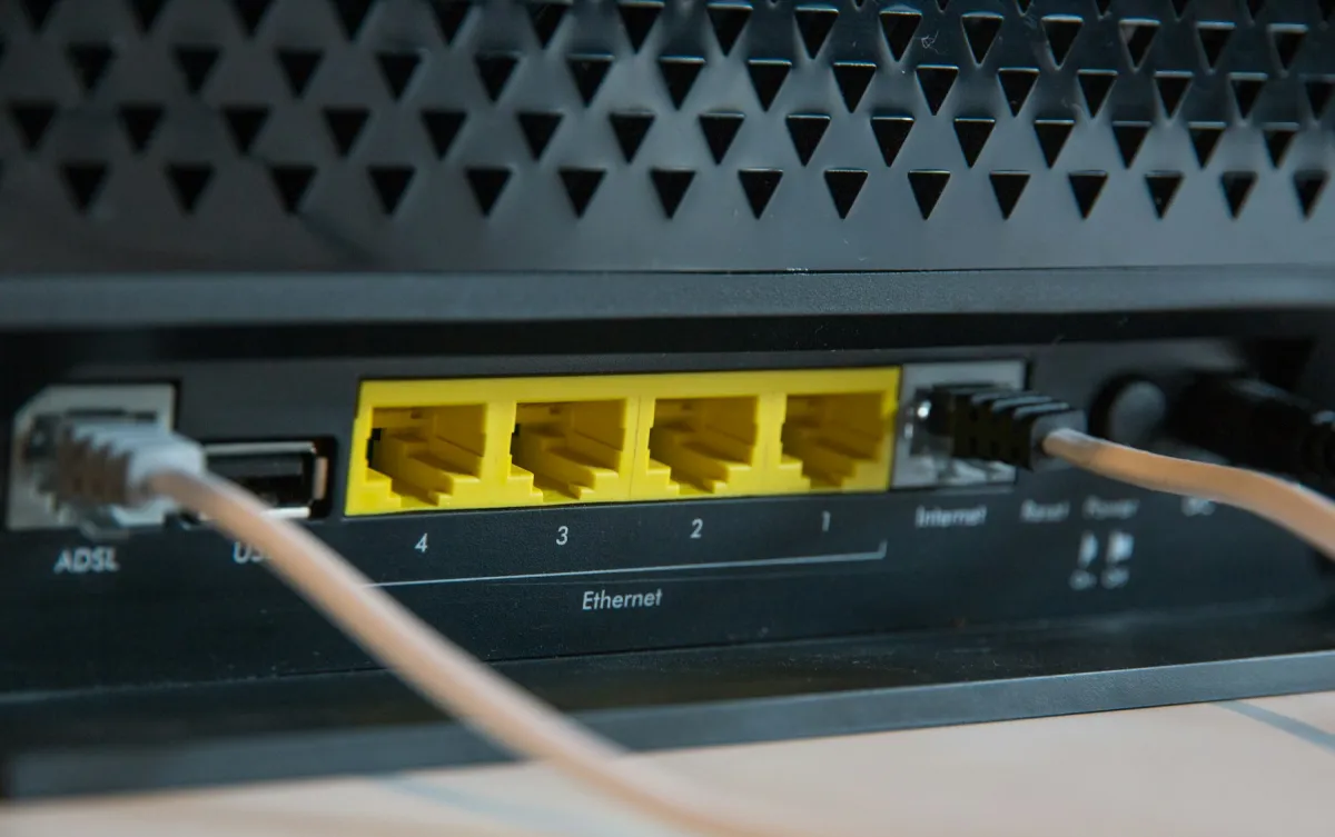 Rear ports of a black router with two cables connected